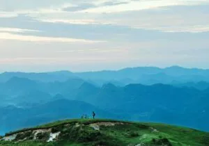 man-standing-on-a-mountain-amongst-earth-300x210